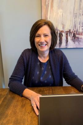 Susan Maynard sitting at a table